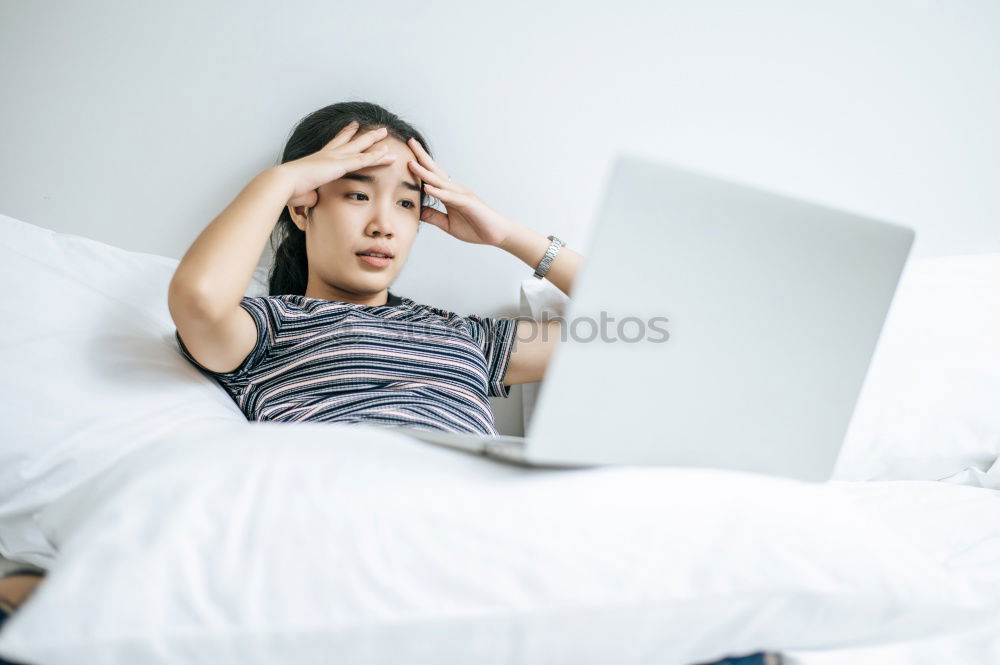 Similar – Young girl looking at mobile phone while sitting on bed