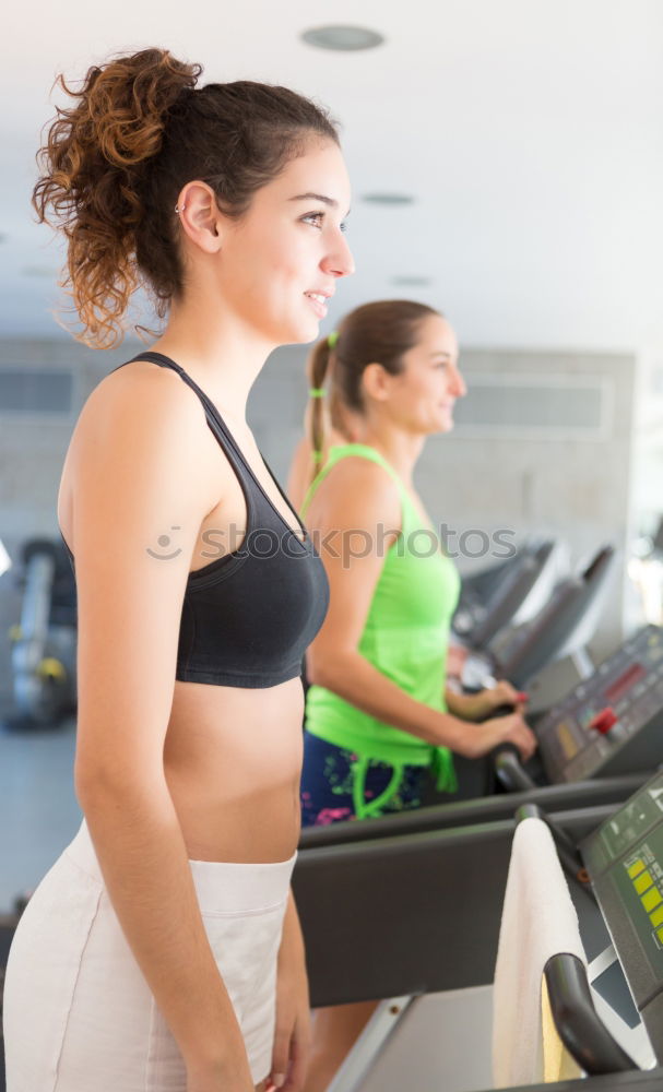 Similar – Woman drinking water while training on treadmill