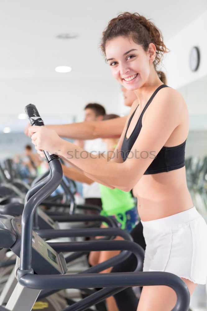 Similar – Woman drinking water while training on treadmill