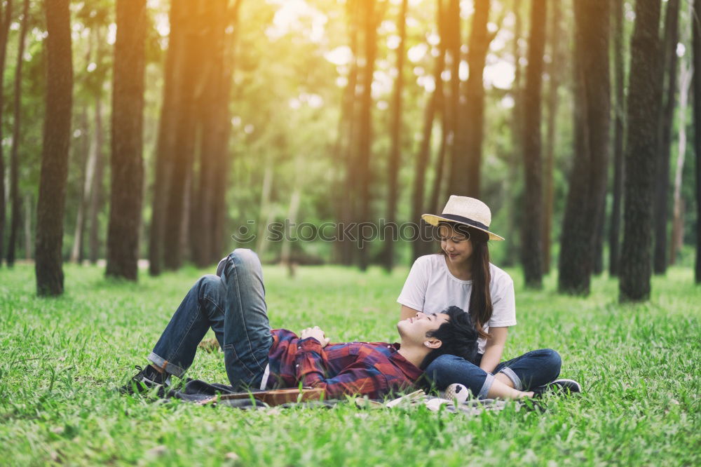 Similar – Young couple under blanket with hot drink kissing outdoors