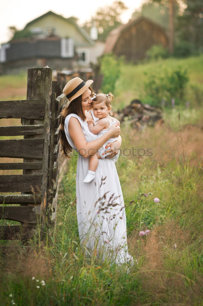 Similar – Grandmother with her grandchildren sitting in the field