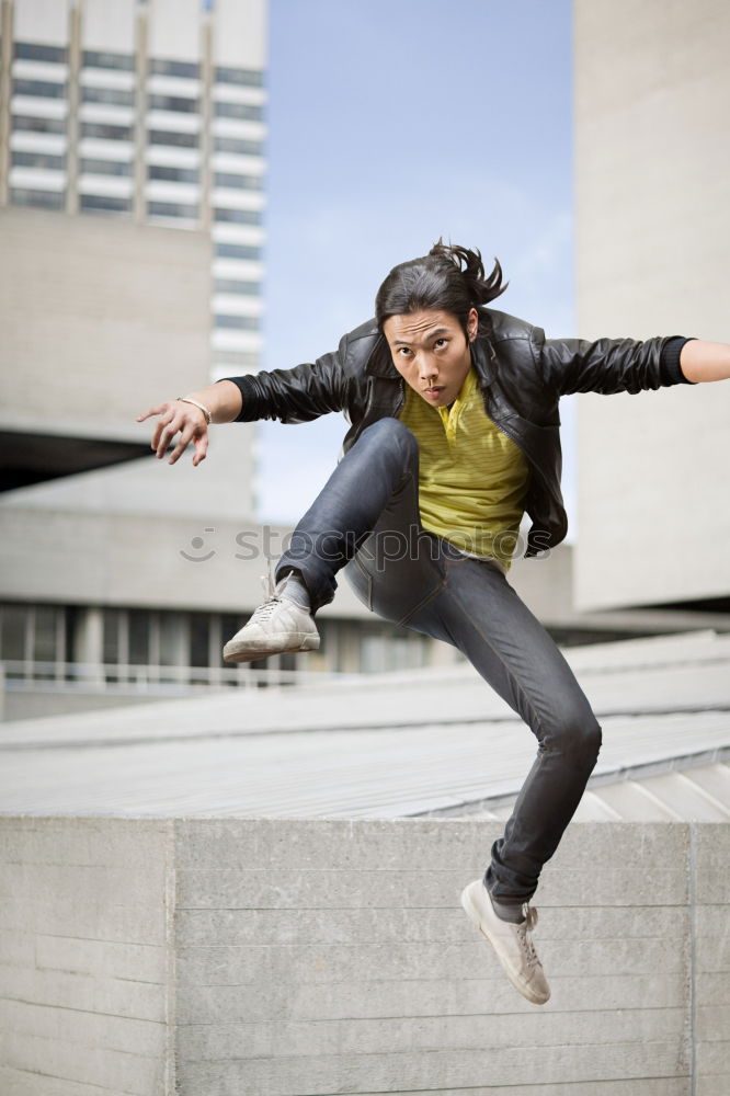 Similar – Woman jumps barefoot on blue rubber hills into the air with outstretched arms