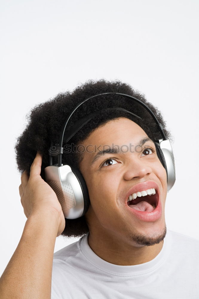 Black serious man listening to music in headphones