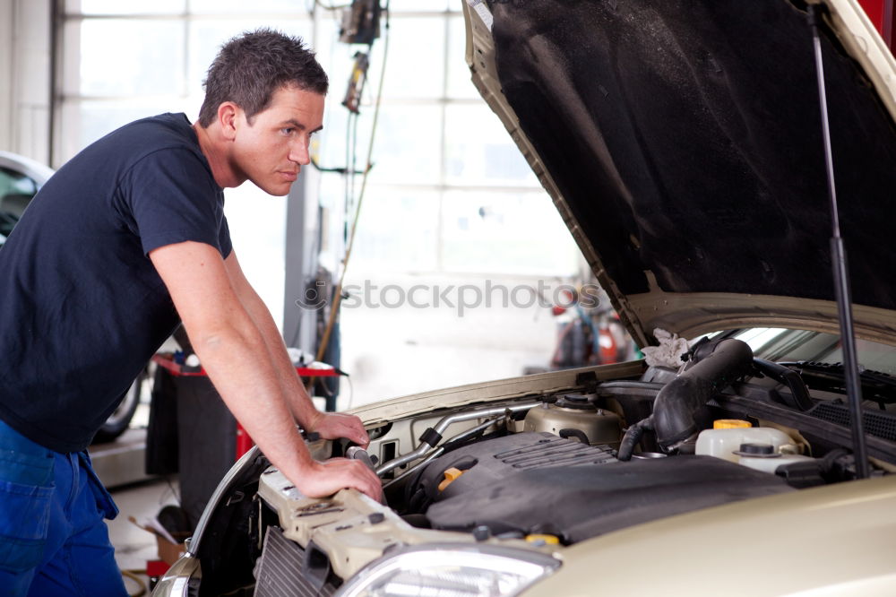 Professional Mechanic Repairing Car.