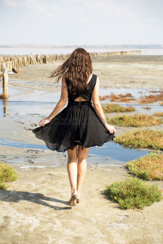 Similar – Beautiful young black woman sitting in a  wooden foot bridge at the beach