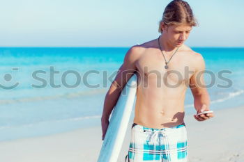 Similar – Young attractive surfer holding his surfboard at the beach