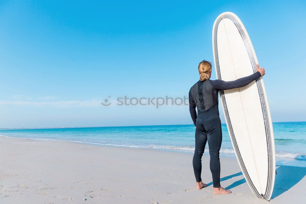 Similar – Image, Stock Photo swimmer putting on his wetsuit on the beach