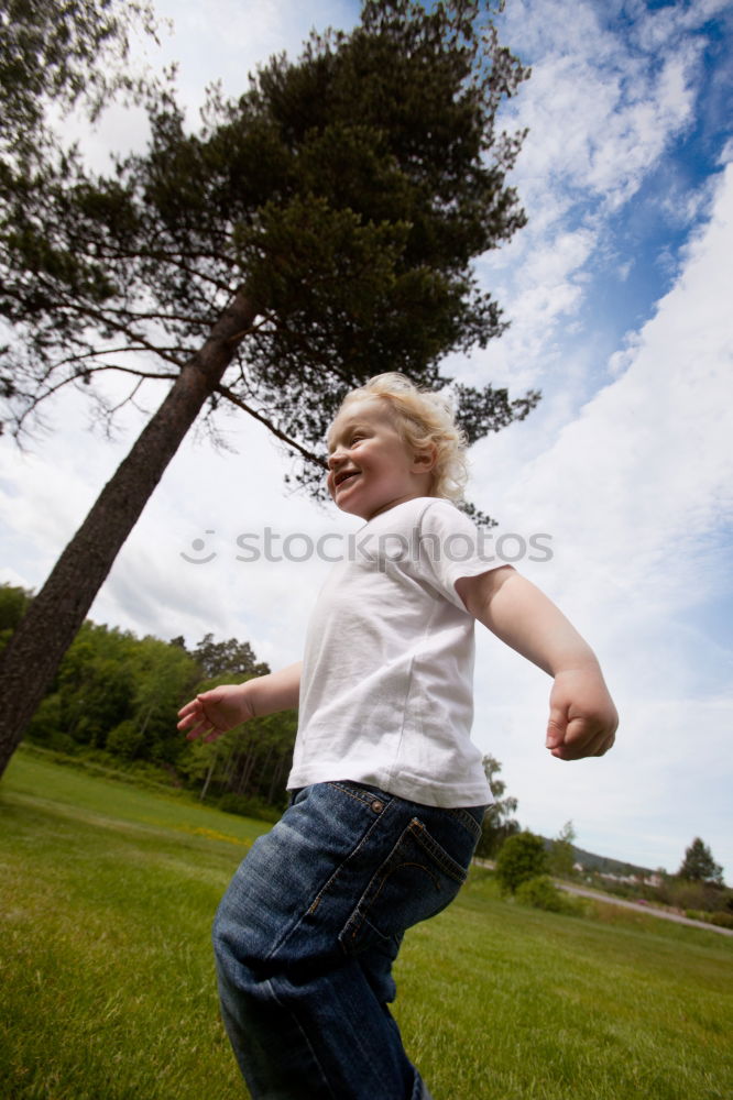 Similar – Image, Stock Photo Funny, funny, cheerful, happy, funny blonde girl outside in the garden, looks up and stretches both arms up to the tree. Little joker does nonsense, sticks out her tongue, in nature, in the park under the tree.