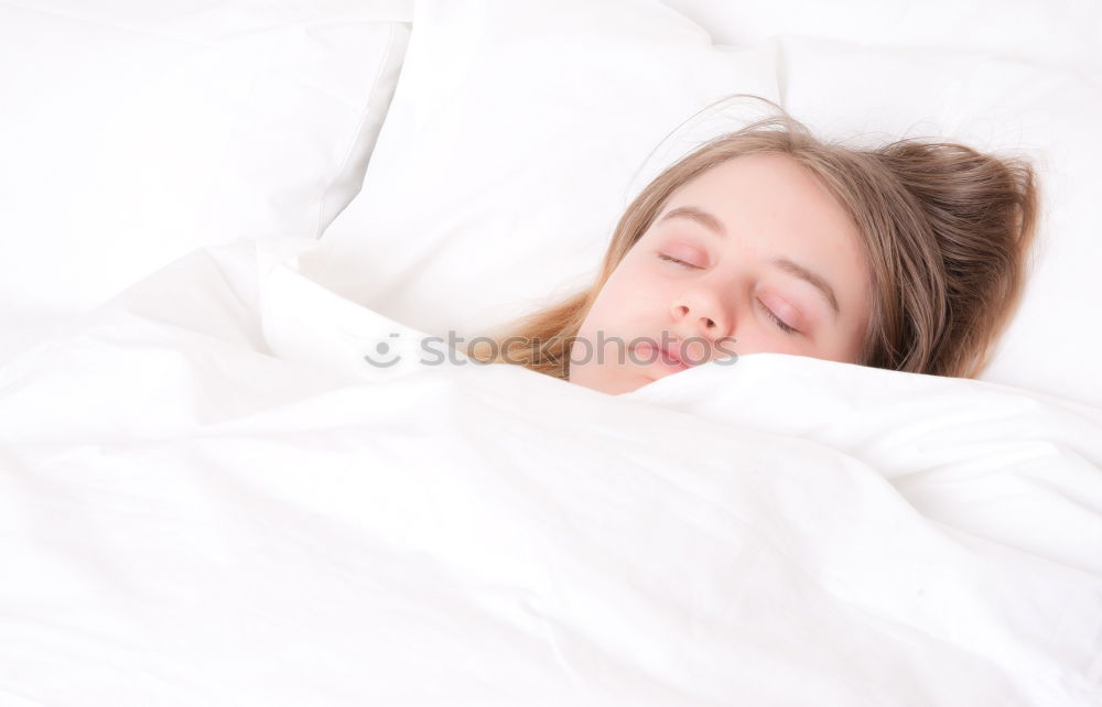 Similar – Little girl lying in a bed with teddy bear at the morning