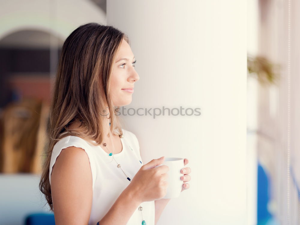 Similar – Young woman sitting at a kitchen table