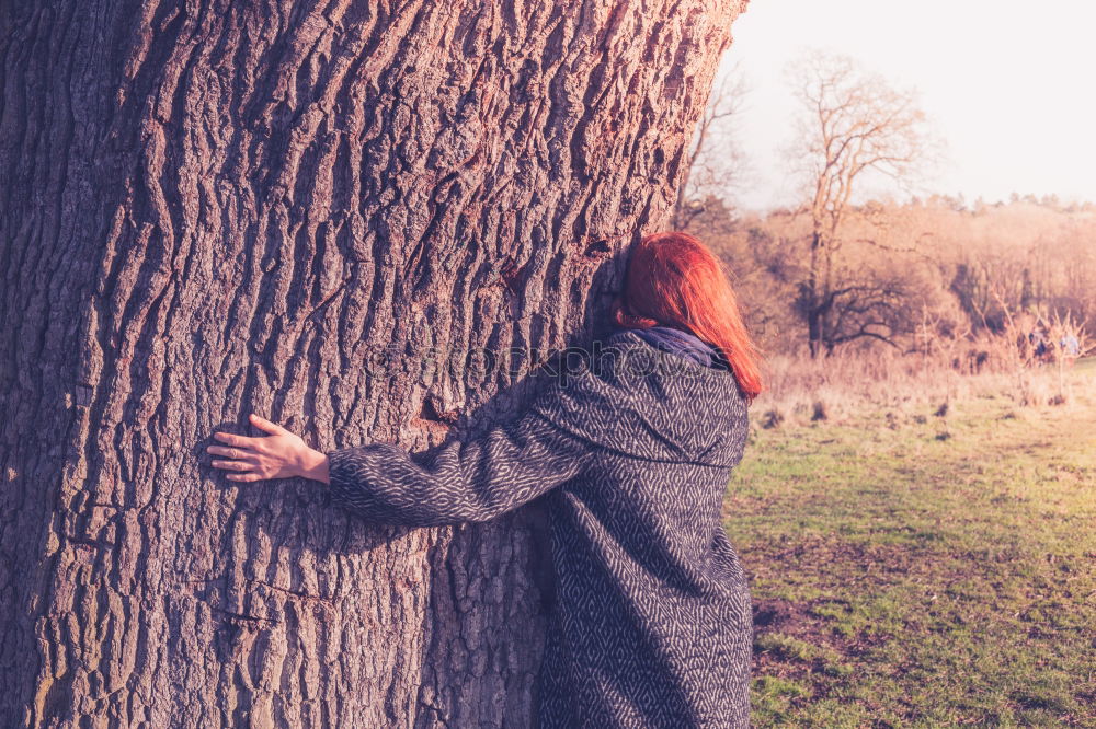 Similar – Image, Stock Photo Woman with knitted hat and coat hugs a tree, dreaming in nature.