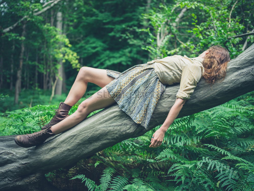 Similar – Woman relaxing on tree trunk