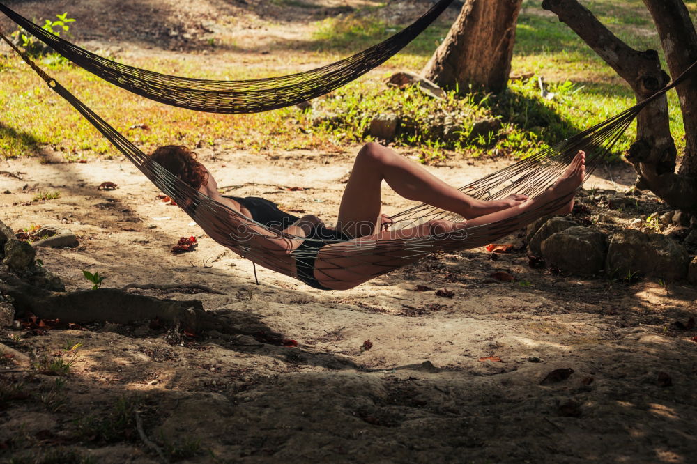 Similar – Image, Stock Photo Young tattooed woman with turquoise hair sits barefoot in beach forest leaning against tree and smiles at camera