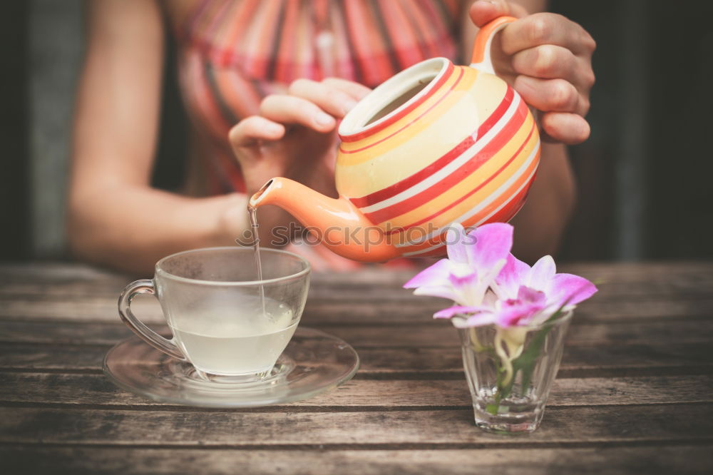 Similar – female hands holding an iron mug with carrot juice