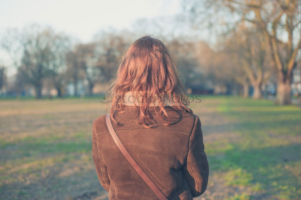 Similar – Young woman on a swing on a playground