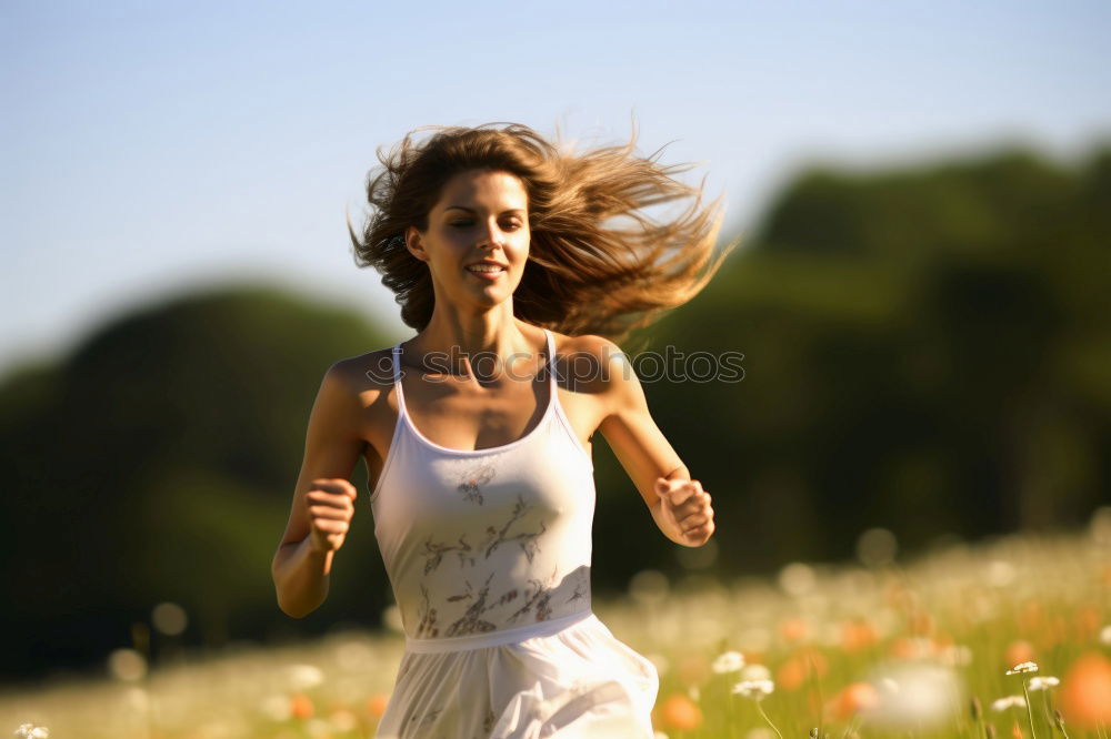 Similar – Young woman jogging down an autumn street