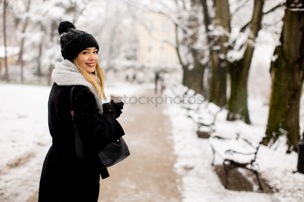 Similar – Foto Bild Eine Frau in warmer Winterkleidung schaut in die Kamera und lächelt im Winter