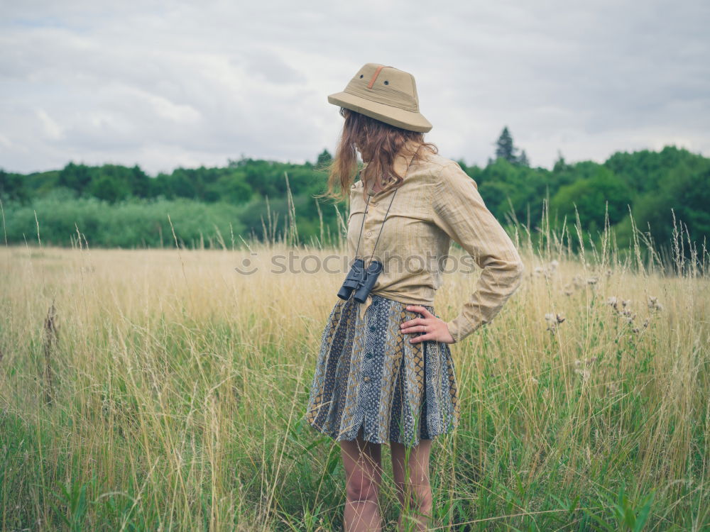 Similar – Image, Stock Photo Portrait of a young woman in a summer dress, standing in a field and turning around smiling