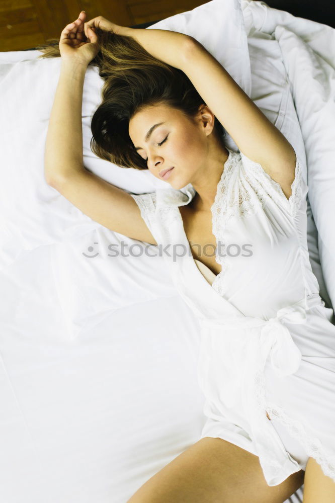 Similar – young dark skinned woman lies in lingerie on the bed and smiles into the camera