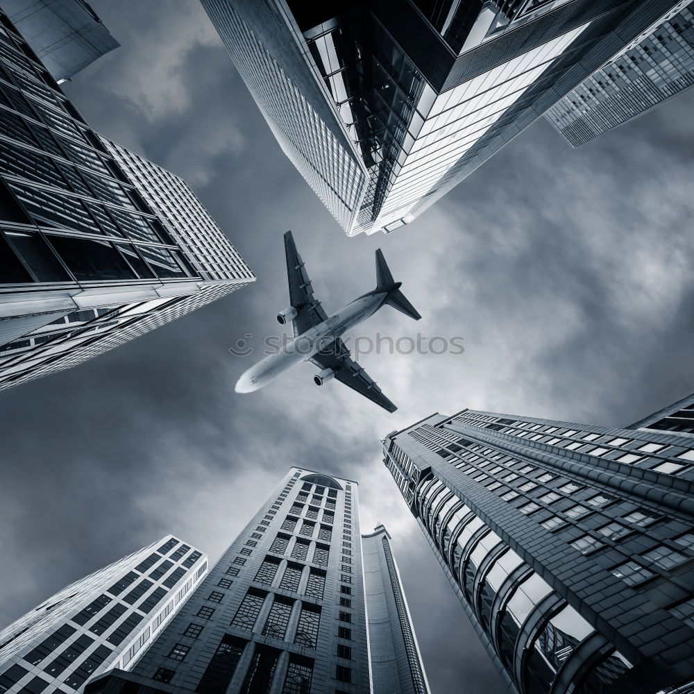 Similar – Plane flying over building