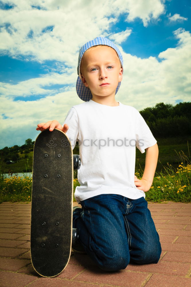 Similar – Image, Stock Photo A smiling boy with skateboard sitting alone on the floor