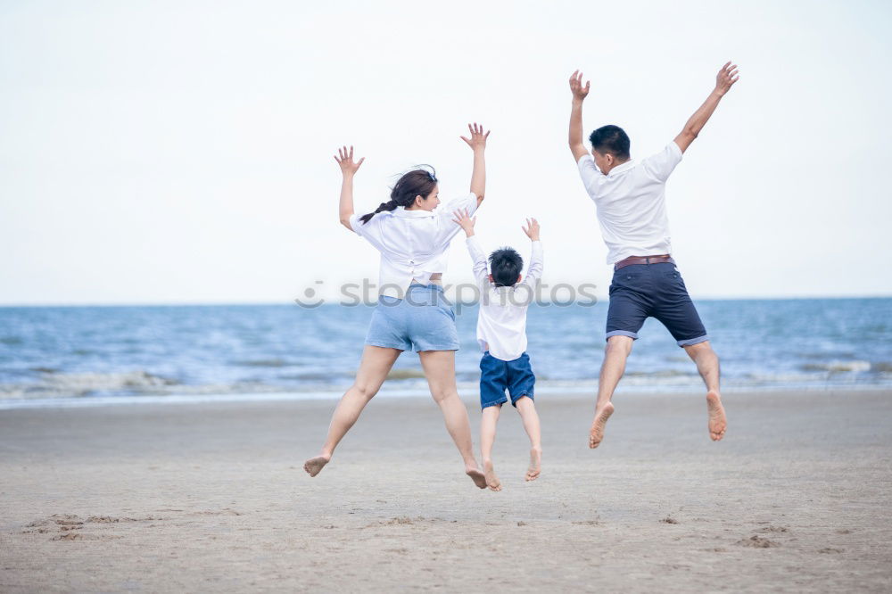 Similar – Father and daughter with balloons playing on the beach