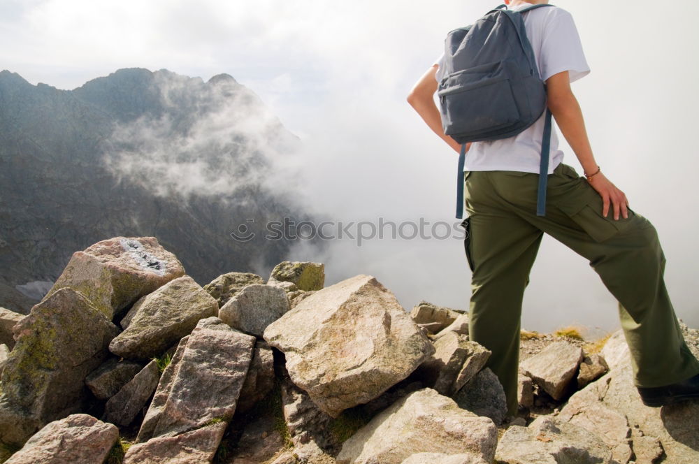 Similar – Woman walking in the mountains with sticks in her hands