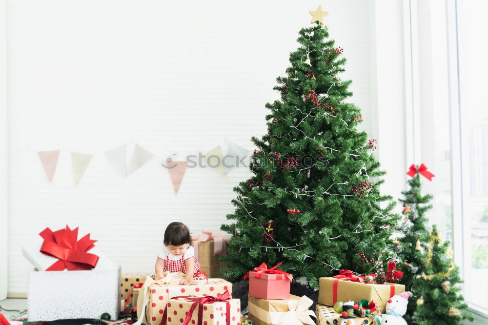 Similar – Young girl and her little sister decorating Christmas tree