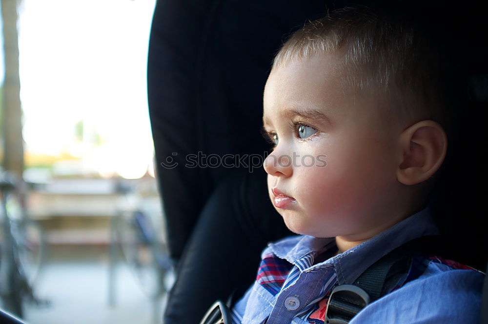 Similar – Image, Stock Photo One little boy sitting in the car and look out from the car window at the day time. Concept of happy trip.