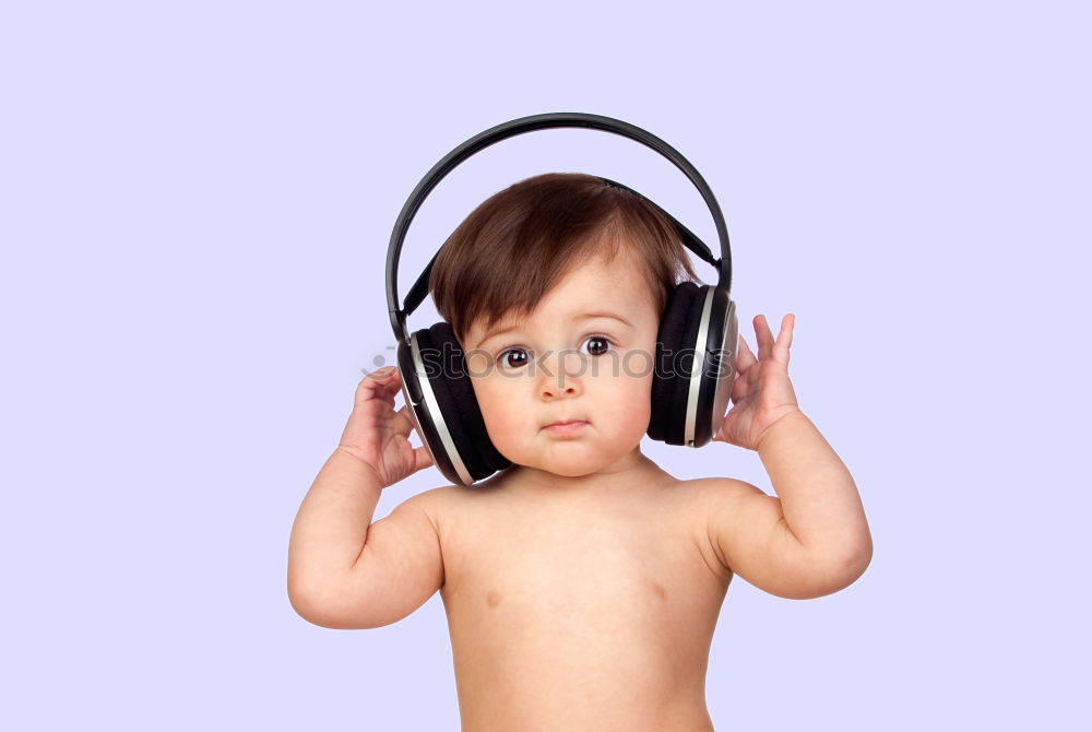 Similar – Child with headphones, listening to music