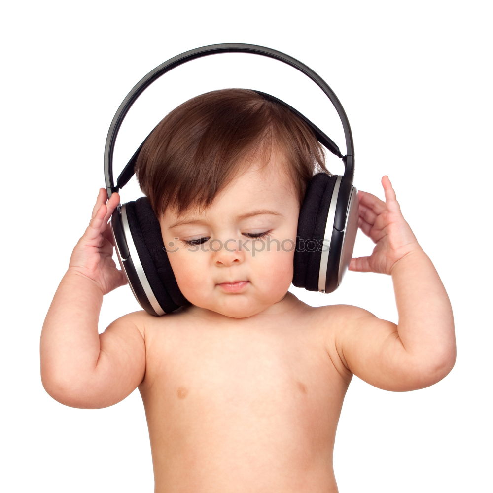 Similar – Child with headphones, listening to music