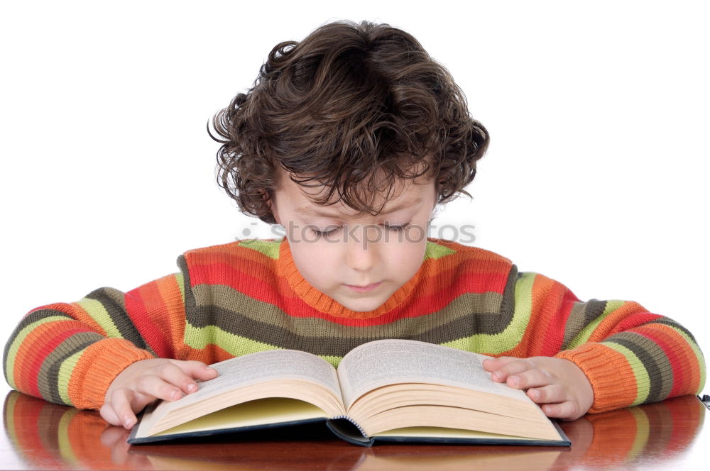 Similar – boy reading books on gray background