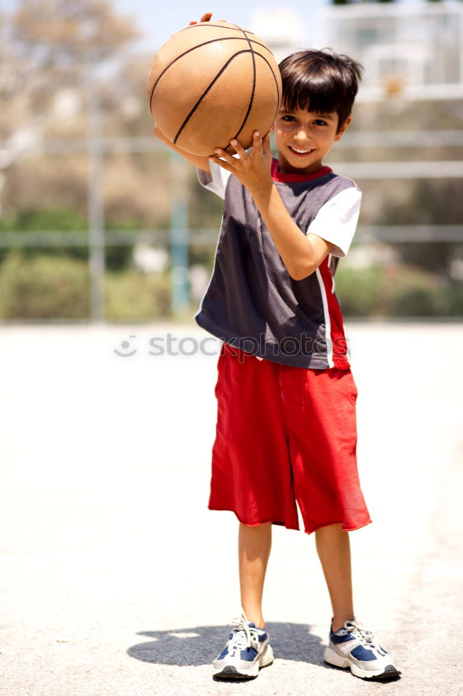 Similar – Teenage playing basketball on an outdoors court