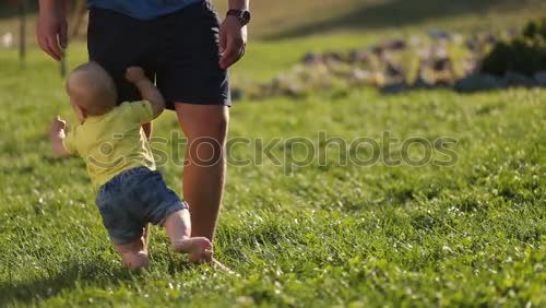 Similar – Image, Stock Photo Mother holding walking child