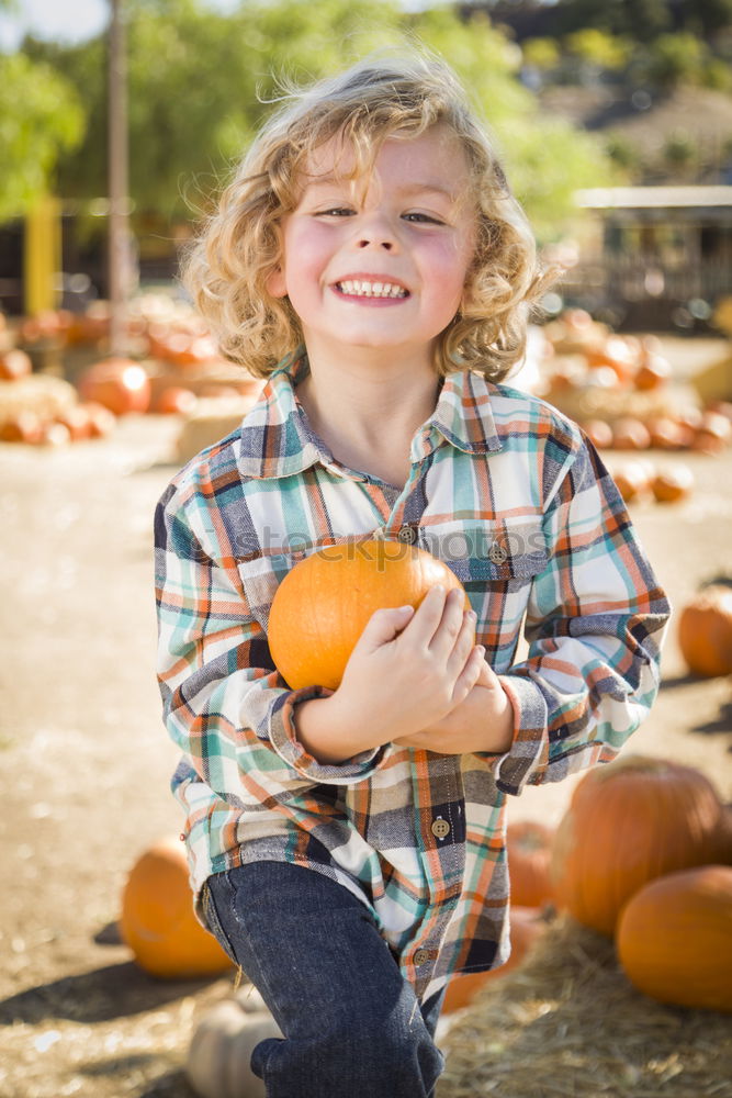 Similar – Image, Stock Photo Adorable girl todler embracing pumpkins on an autumn field