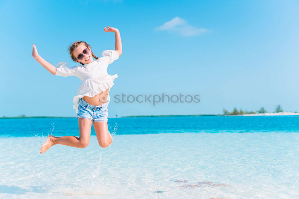 Similar – Happy teen girl jumping on the beach