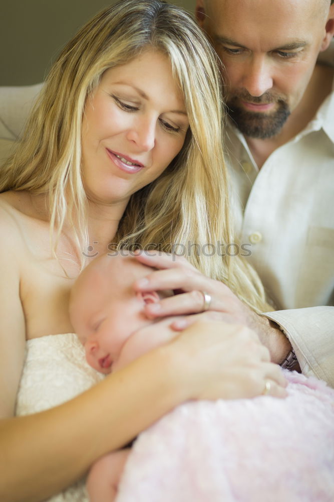 Similar – Image, Stock Photo Couple embracing a newborn over dark background