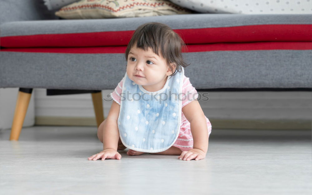 Similar – cute toddler girl put on socks at home