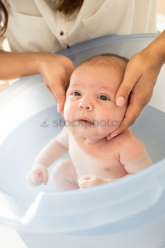 Similar – Bathing newborn baby girl.