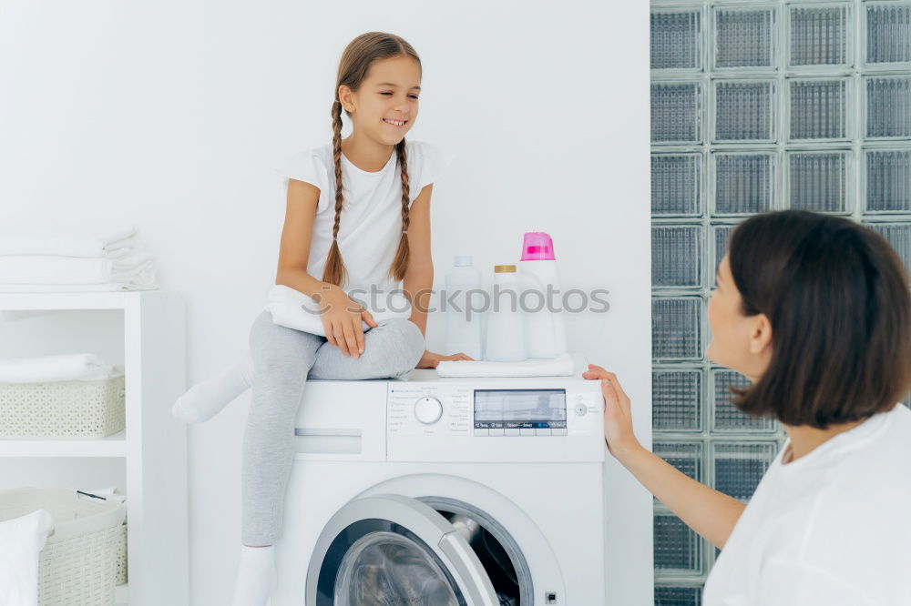 Similar – Woman sitting at laundry machine