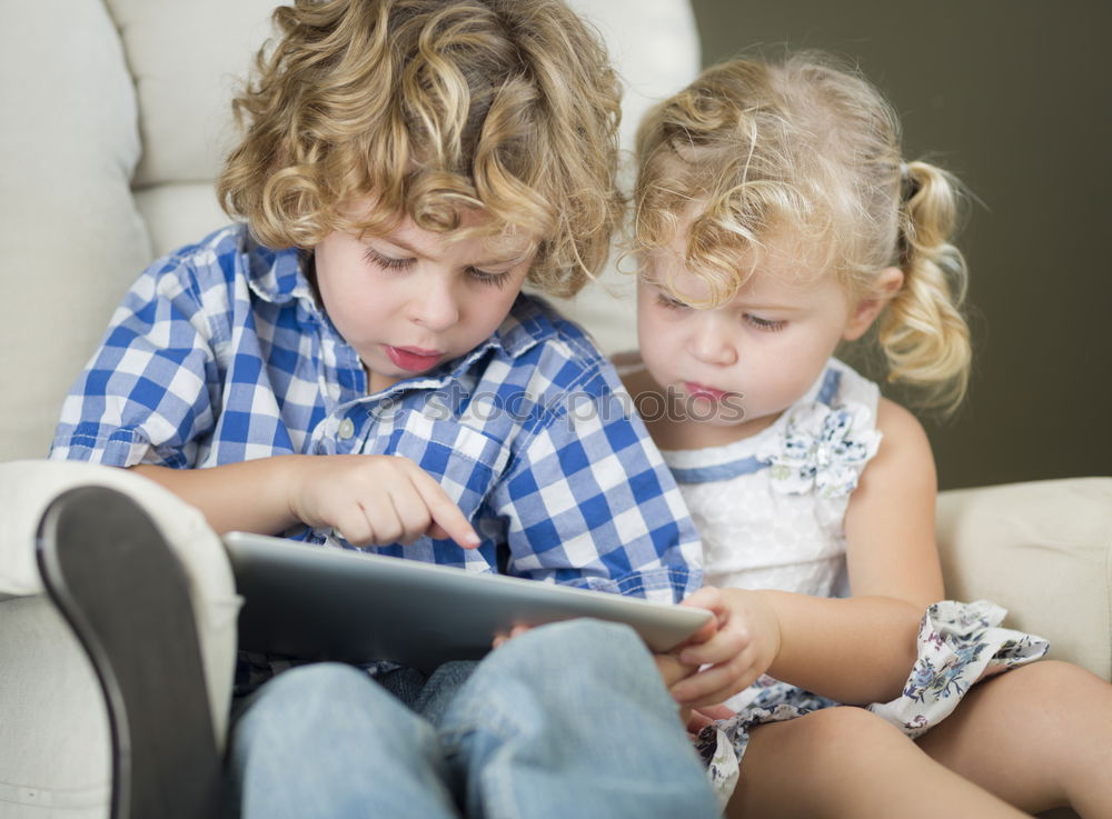 Similar – Three kids using a tablet at home