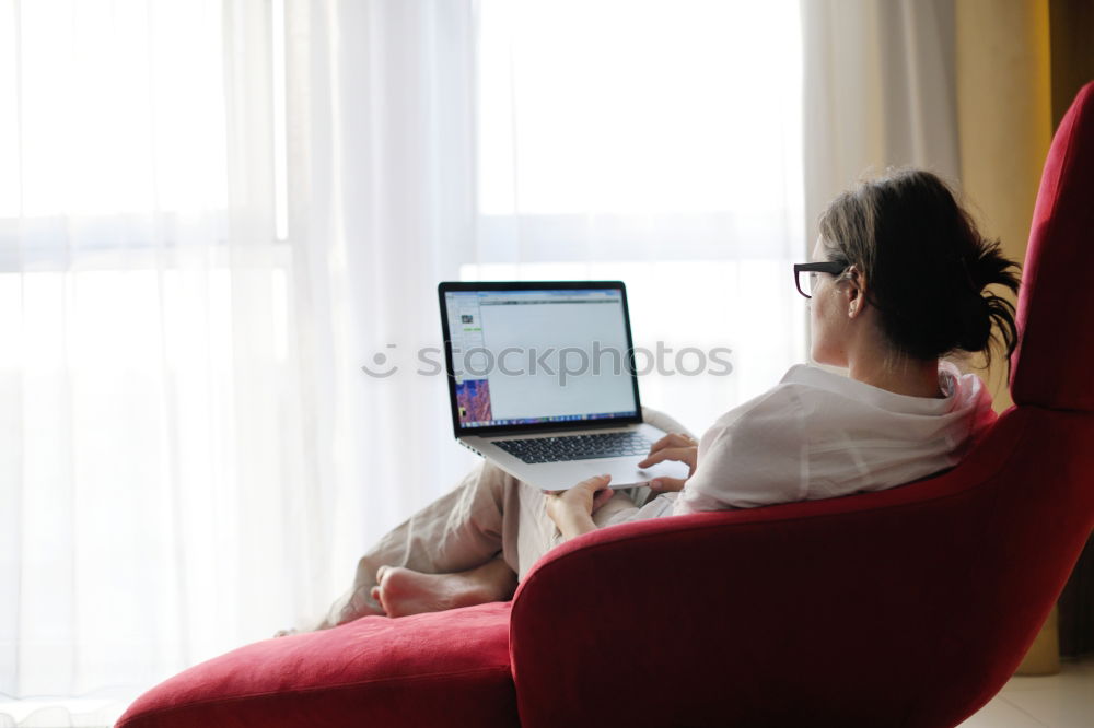 Similar – Mature woman sitting on couch at modern home