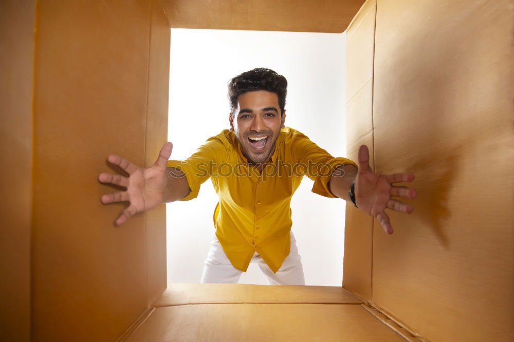 Similar – Young man looks curiously over a barrier