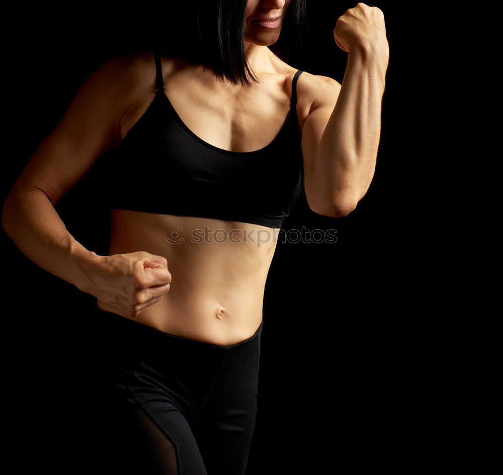 Similar – Image, Stock Photo Close up front portrait of one young athletic woman in sportswear in gym over dark background, standing in boxing stance with hands and fists, looking at camera