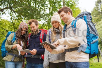 Similar – Image, Stock Photo Couple doing trekking sitting looking mobile and map