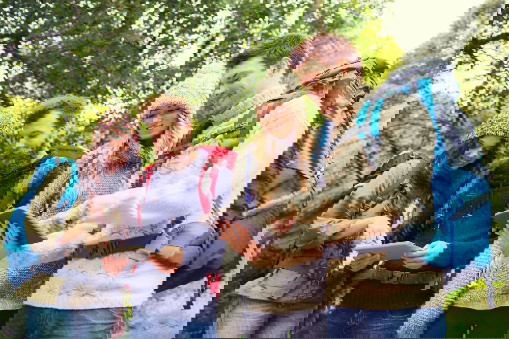Similar – Image, Stock Photo Couple doing trekking sitting looking mobile and map