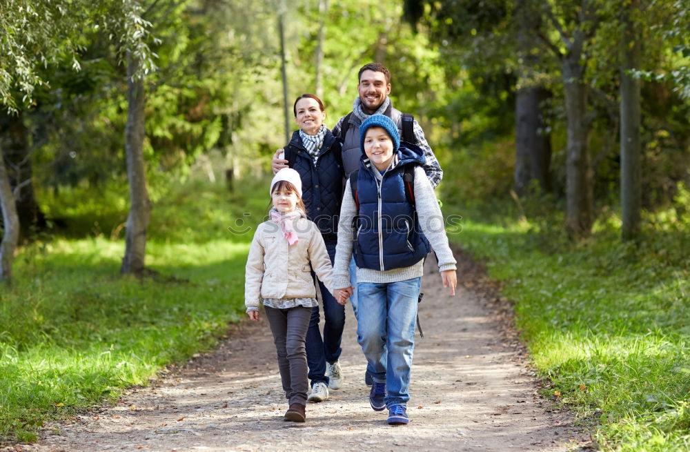 Similar – Grandparents and grandchild jumping on nature path