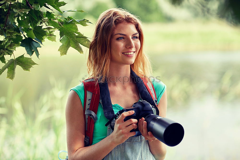 Similar – Close up of a photographer with her camera.