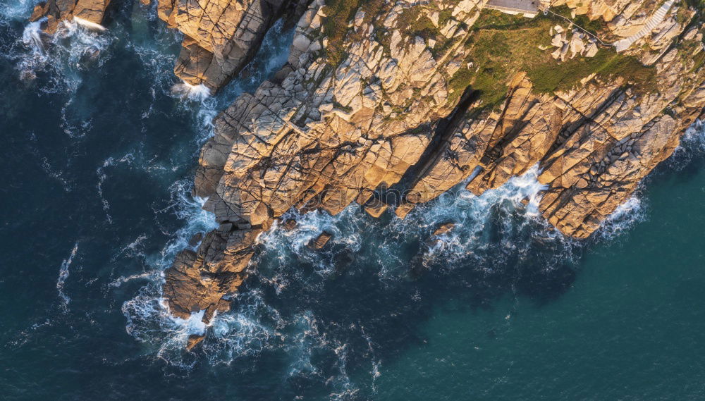 Similar – Aerial views of a coastline with waves and rocks