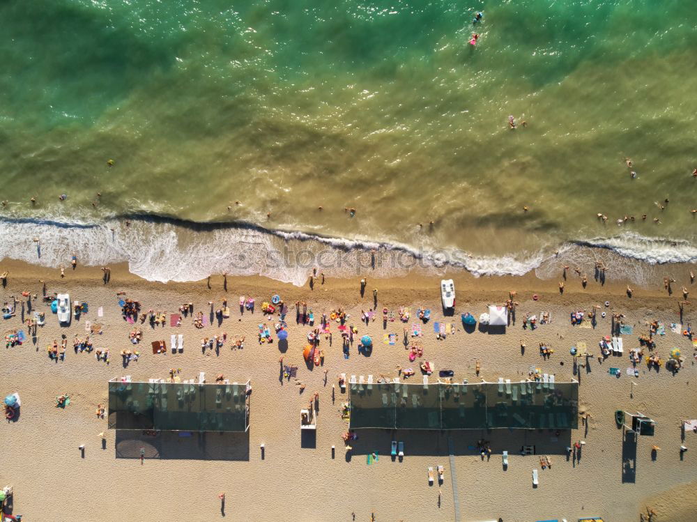 Similar – Drone shot of many people enjoying the beach and the ocean in high season- vacation pattern.